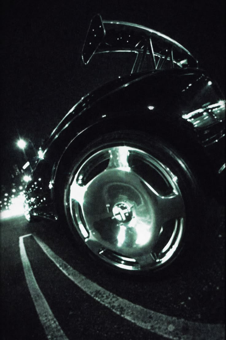 Chrome wheel under streetlight at night